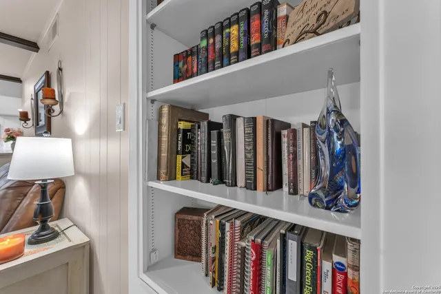 a living room with furniture dining table and a chandelier