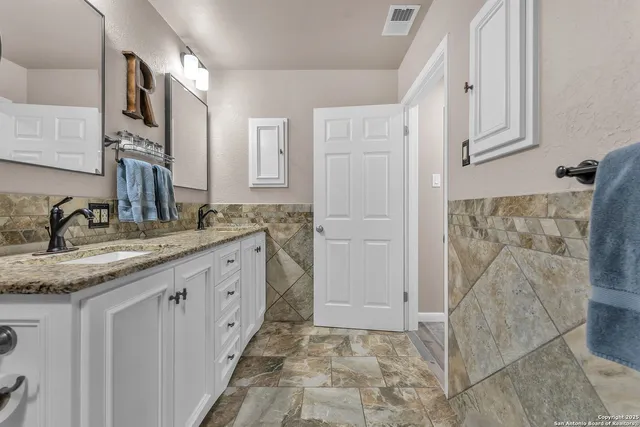 a kitchen with a stove sink and cabinets