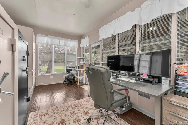 a front view of a house with a garden and tree