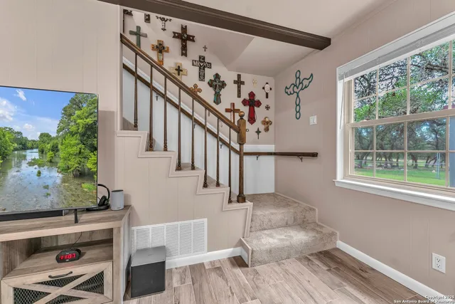 a view of a house with a big yard and palm trees