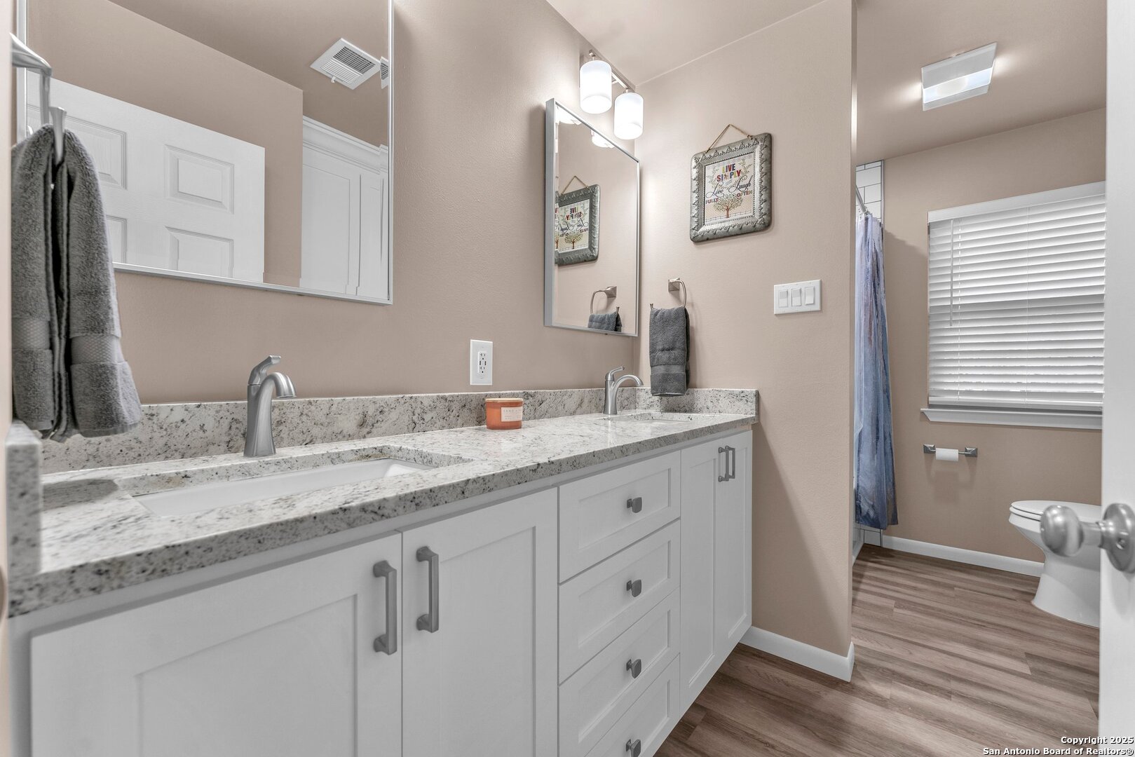 11650 Sunset Ranch Helotes, TX 78023 - Photo 52 of 141 a bathroom with a granite countertop sink mirror and a