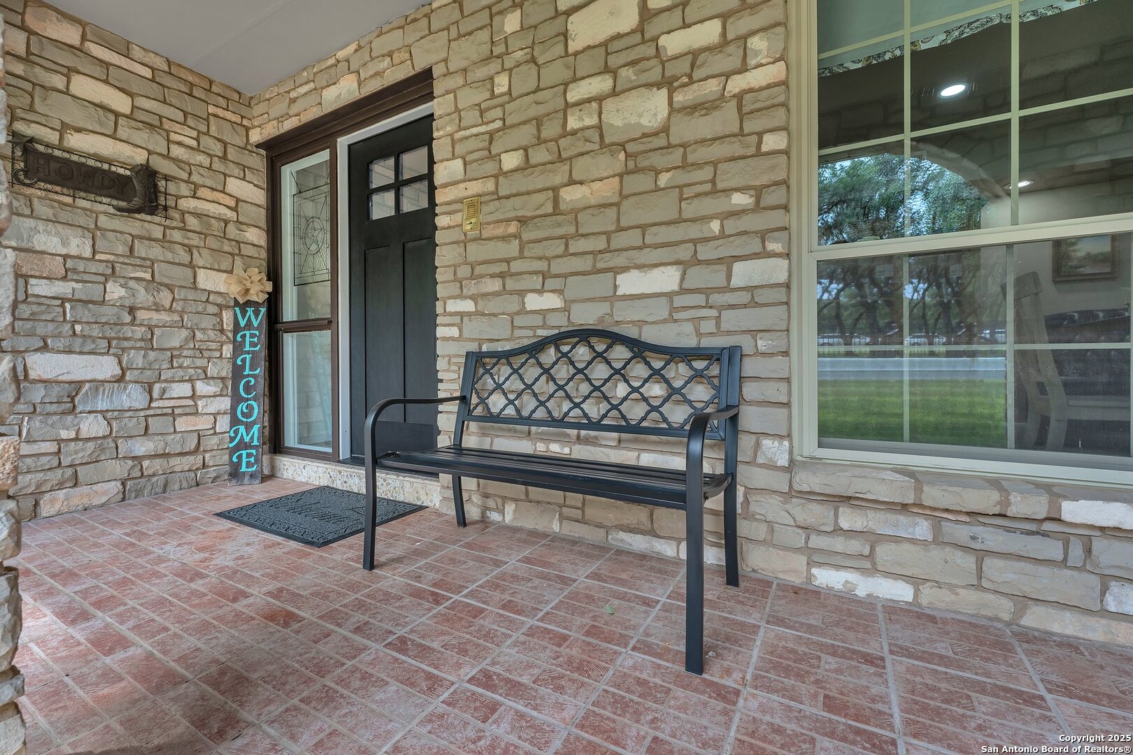 11650 Sunset Ranch Helotes, TX 78023 - Photo 9 of 141 a bench sitting in front of a brick house