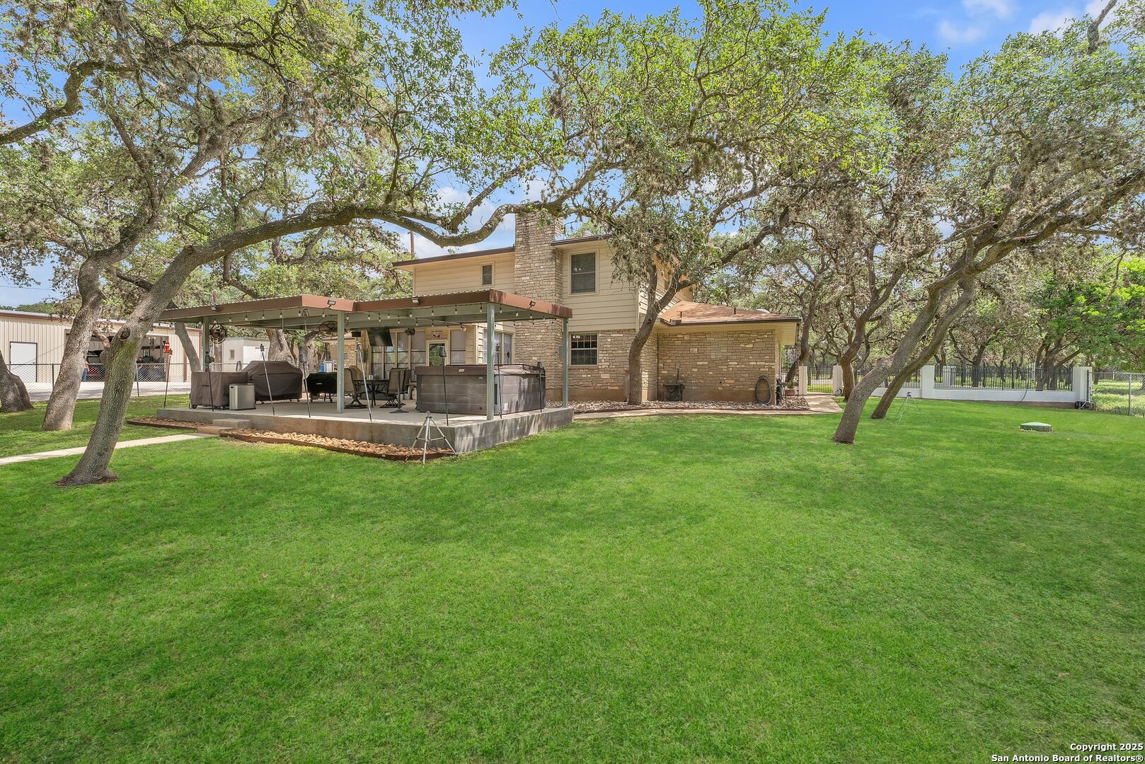 11650 Sunset Ranch Helotes, TX 78023 - Photo 95 of 141 a front view of a house with garden and trees