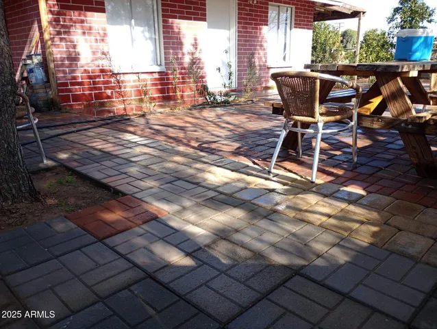 a view of backyard with a patio and outdoor seating