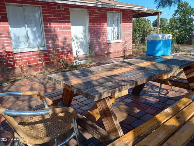 a view of a chairs and tables in the back yard of the house