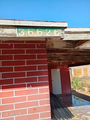 a view of a patio with table and chairs and wooden floor