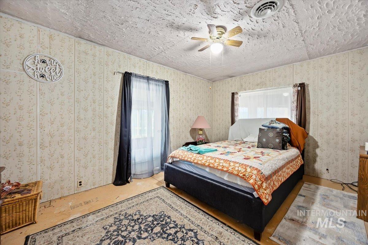 534 Miller Avenue Burley, ID 83318 - Photo 15 of 27 Bedroom featuring a ceiling fan, multiple windows, and a textured ceiling