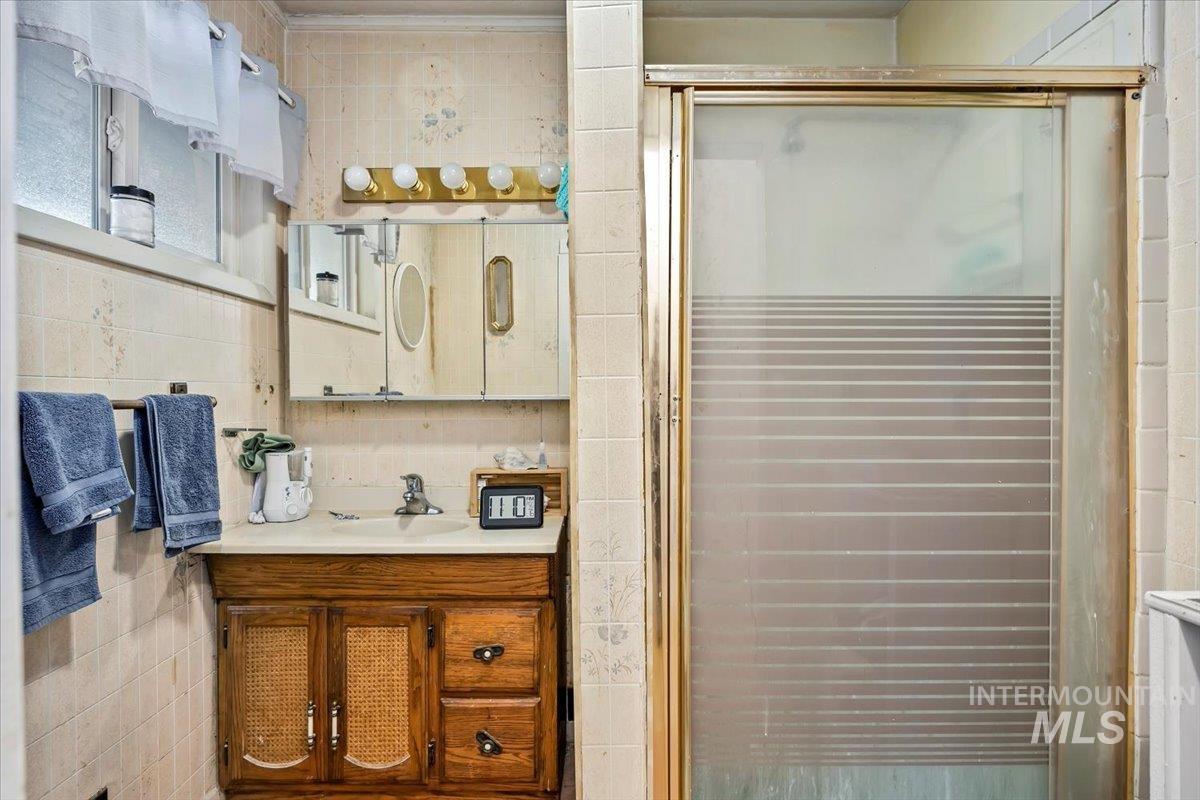534 Miller Avenue Burley, ID 83318 - Photo 16 of 27 Bathroom with vanity, a stall shower, and tile walls
