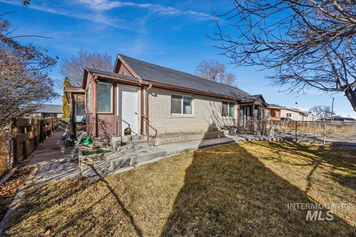534 Miller Avenue Burley, ID 83318 - Photo 2 of 27 Rear view of property featuring a fenced backyard, entry steps, and brick siding