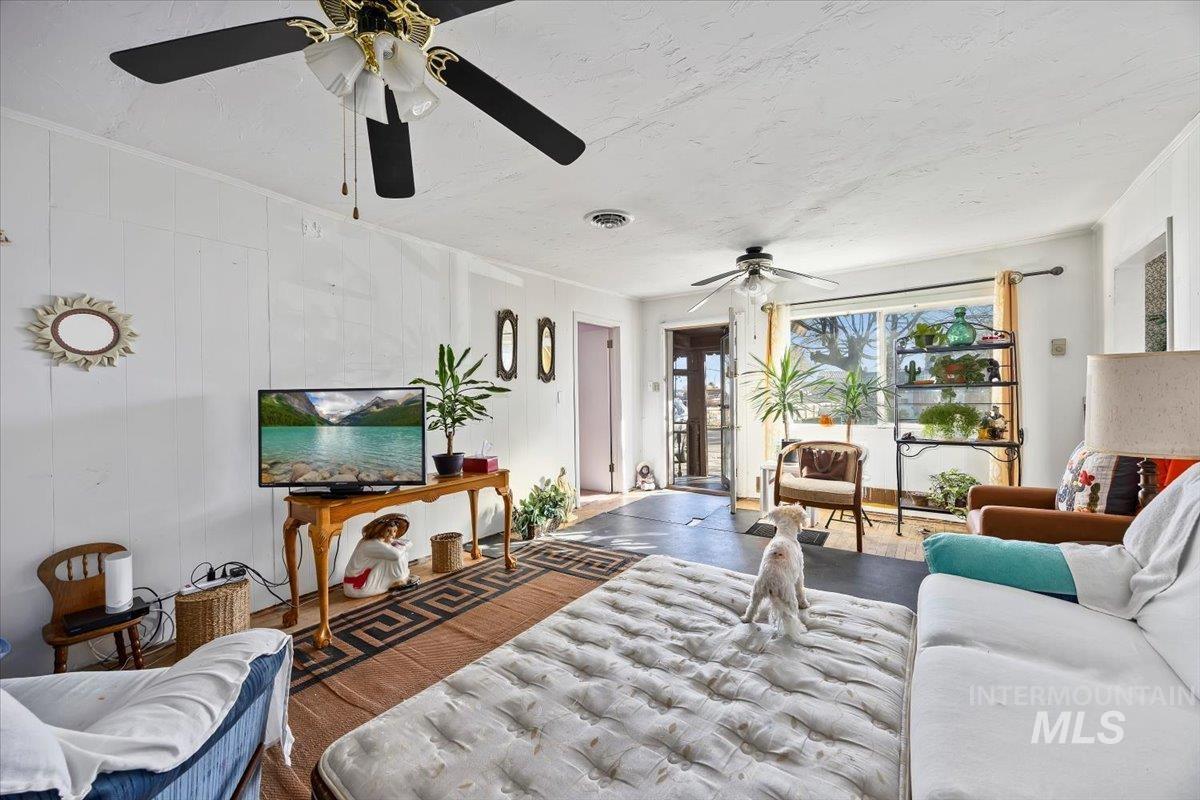534 Miller Avenue Burley, ID 83318 - Photo 3 of 27 Living area with a ceiling fan and ornamental molding