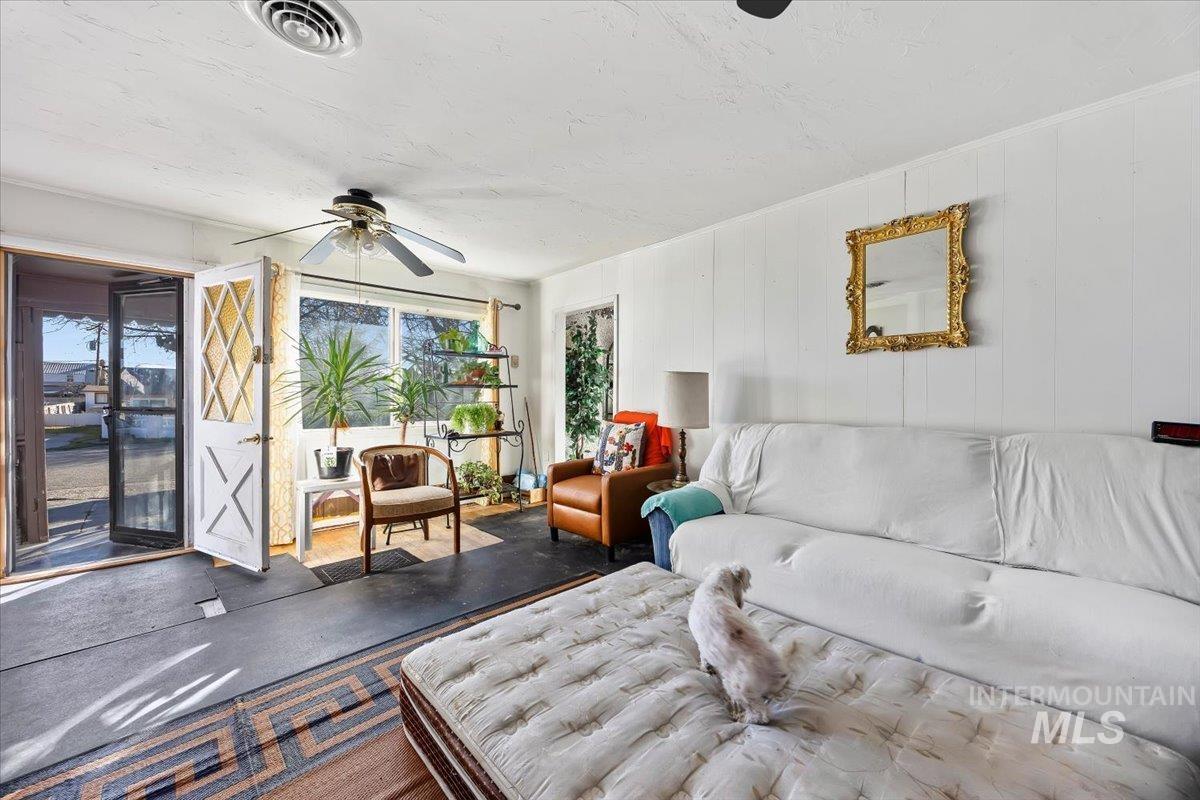 534 Miller Avenue Burley, ID 83318 - Photo 4 of 27 Living room with a ceiling fan and wood walls