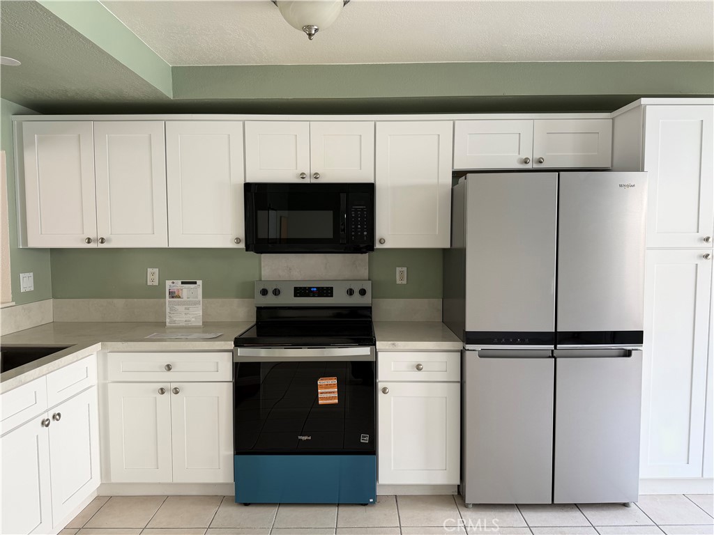 25885 Trabuco Road, Unit 235 Lake Forest, CA 92630 - Photo 8 of 16 a kitchen with cabinets stainless steel appliances and a sink