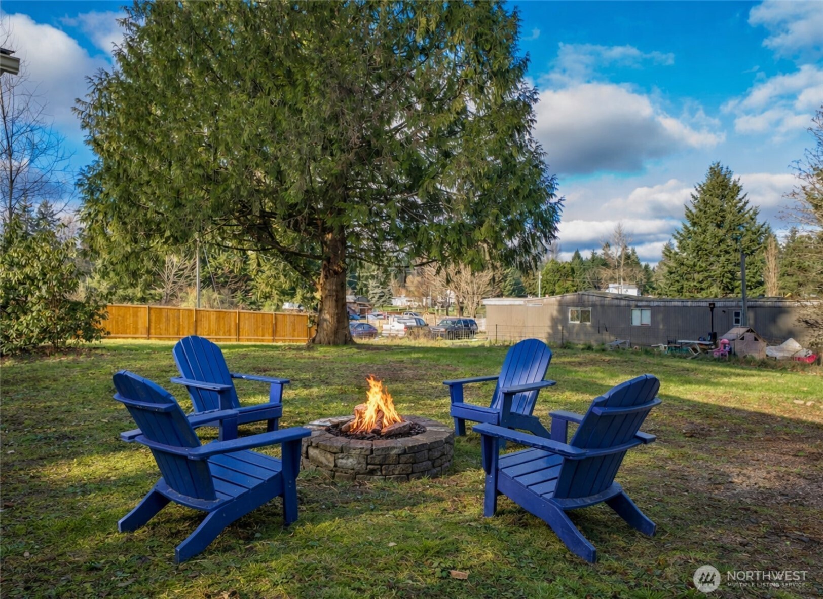 733 Tipsoo Loop South Rainier, WA 98576 - Photo 27 of 37 a view of a lake with a lounge chairs and a fire pit