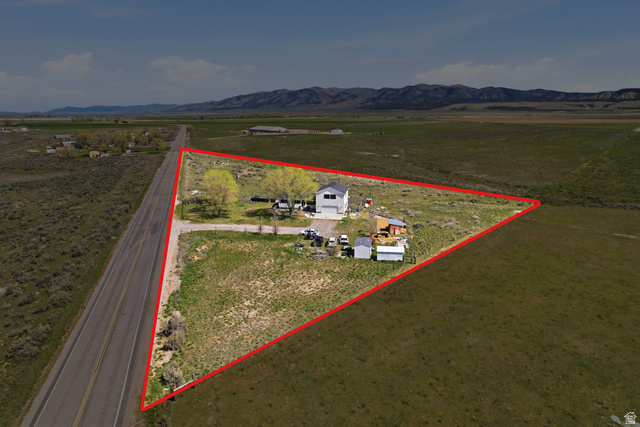 830 North Stone Road Snowville, UT 84336 - Photo 38 of 69 Aerial view of sparsely populated area featuring property boundaries highlighted and a mountainous background