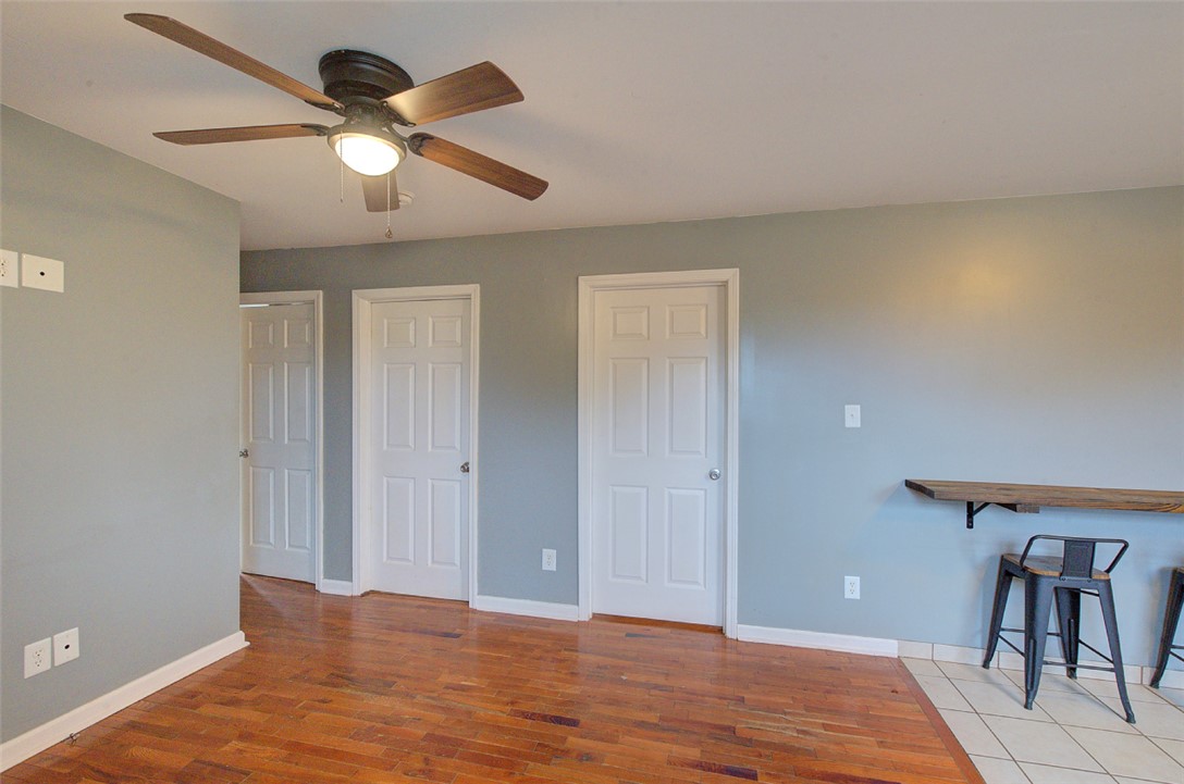 325 Rock Quarry Road Travelers Rest, SC 29690 - Photo 10 of 37 This versatile living space features warm wood flooring and convenient ceiling fan for comfort.