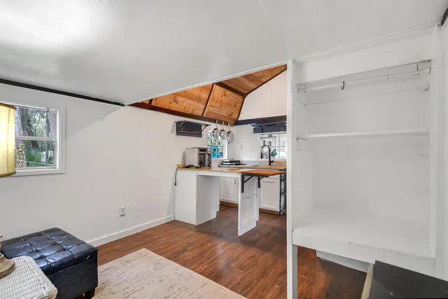 a view of kitchen with furniture and wooden floor