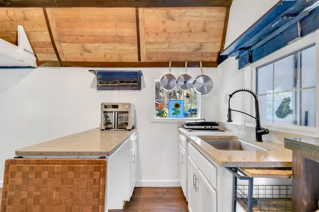 a kitchen with stainless steel appliances a sink a stove and a refrigerator
