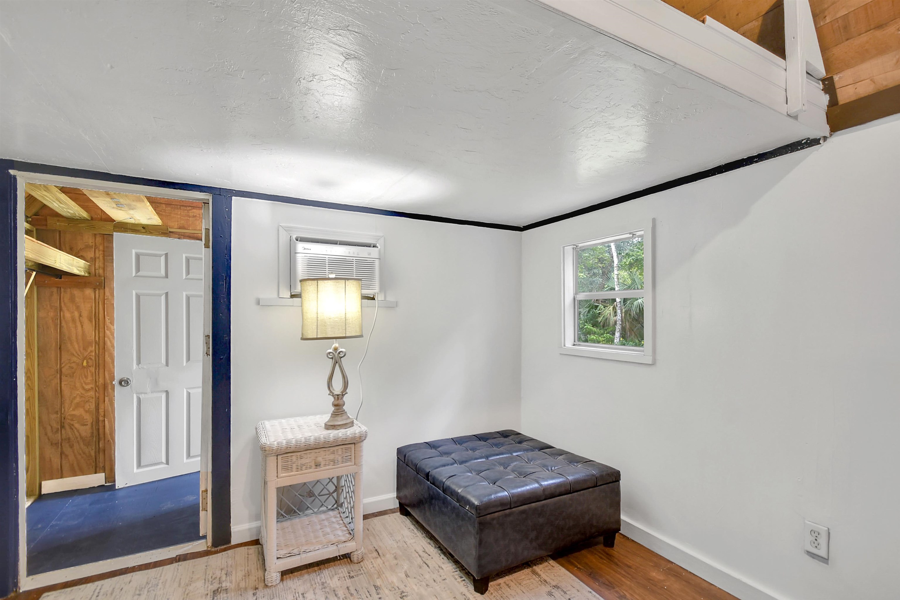 4895 Ave D, Unit B St. Augustine, FL 32095 - Photo 14 of 22 a living room with furniture and a window