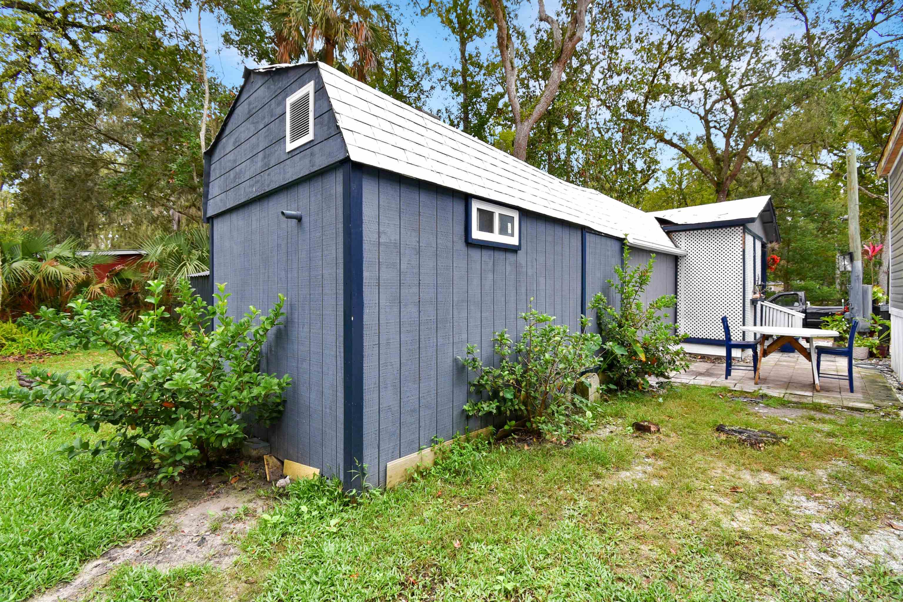 4895 Ave D, Unit B St. Augustine, FL 32095 - Photo 2 of 22 a view of backyard with table and chairs and potted plants