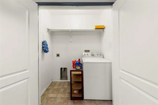 a kitchen with furniture a refrigerator and a stove top oven