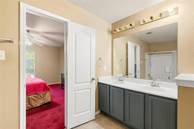 a en suite bathroom with a sink and a mirror
