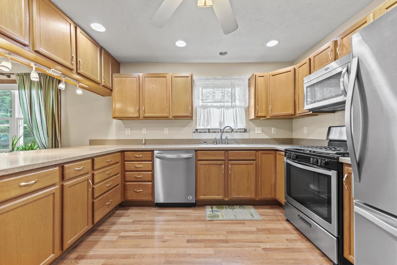 816 Lake Summerset Road Lake Summerset, IL 61019 - Photo 13 of 29 a kitchen with stainless steel appliances granite countertop a stove a sink and a microwave
