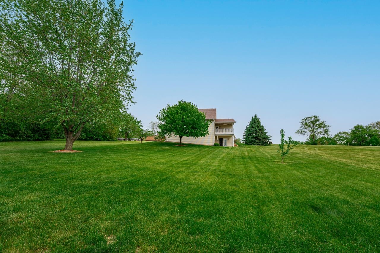 816 Lake Summerset Road Lake Summerset, IL 61019 - Photo 17 of 29 a view of a garden with a house in the background