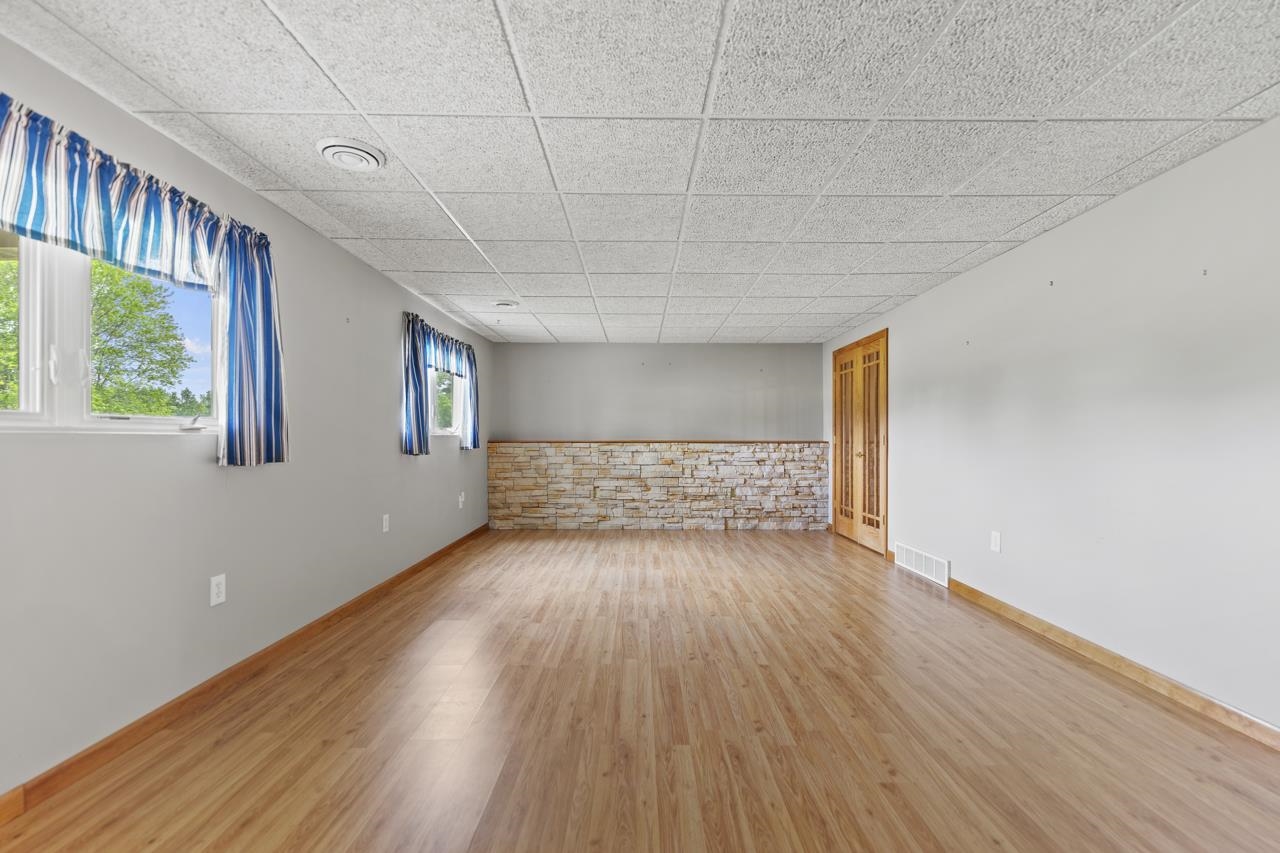 816 Lake Summerset Road Lake Summerset, IL 61019 - Photo 27 of 29 a view of an empty room with wooden floor and a window