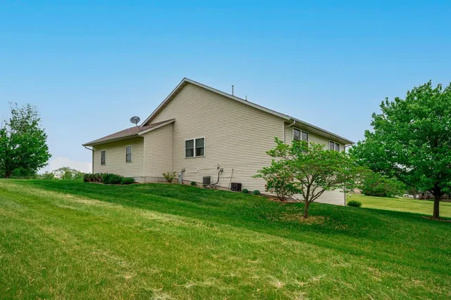 a front view of a house with a yard and trees