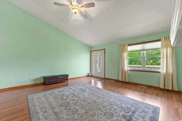 a kitchen with stainless steel appliances granite countertop a refrigerator a oven a sink and a wooden floors