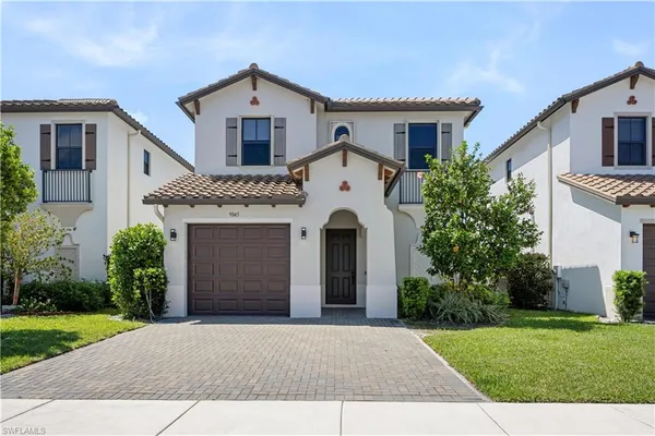 a front view of a house with a yard and garage