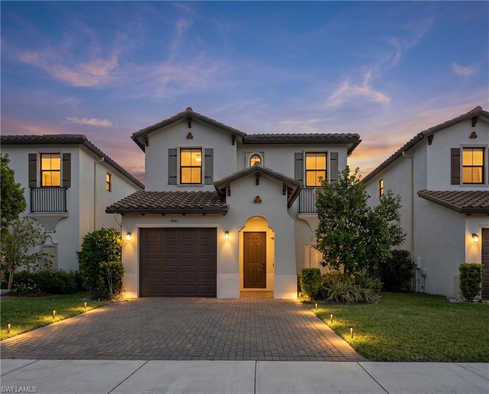 9045 Madrid Circle Naples, FL 34104 - Photo 1 of 46 Mediterranean-inspired architecture featuring a terracotta tile roof and stucco exterior