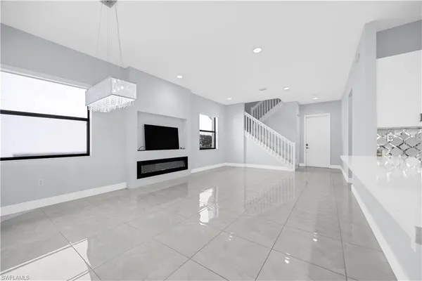 a view of a livingroom with an empty space and a fireplace