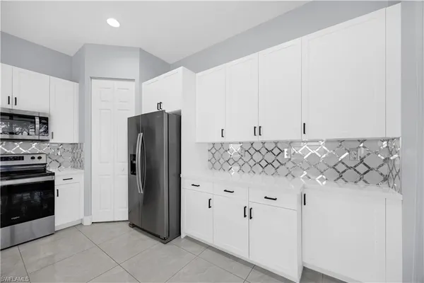 a kitchen with stainless steel appliances granite countertop a refrigerator and a stove