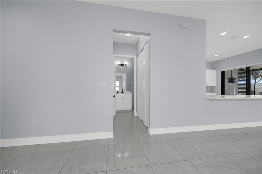 9045 Madrid Circle Naples, FL 34104 - Photo 19 of 46 an empty room with windows and entrance