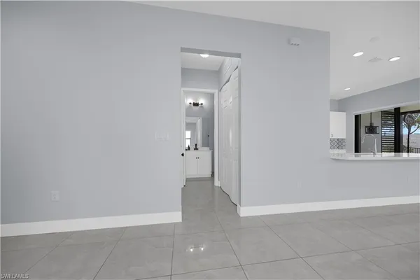 an empty room with windows and entrance