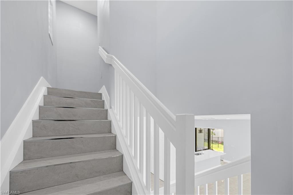 9045 Madrid Circle Naples, FL 34104 - Photo 20 of 46 a view of entryway with stairs