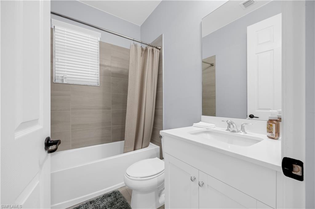 9045 Madrid Circle Naples, FL 34104 - Photo 23 of 46 a bathroom with a sink toilet and shower