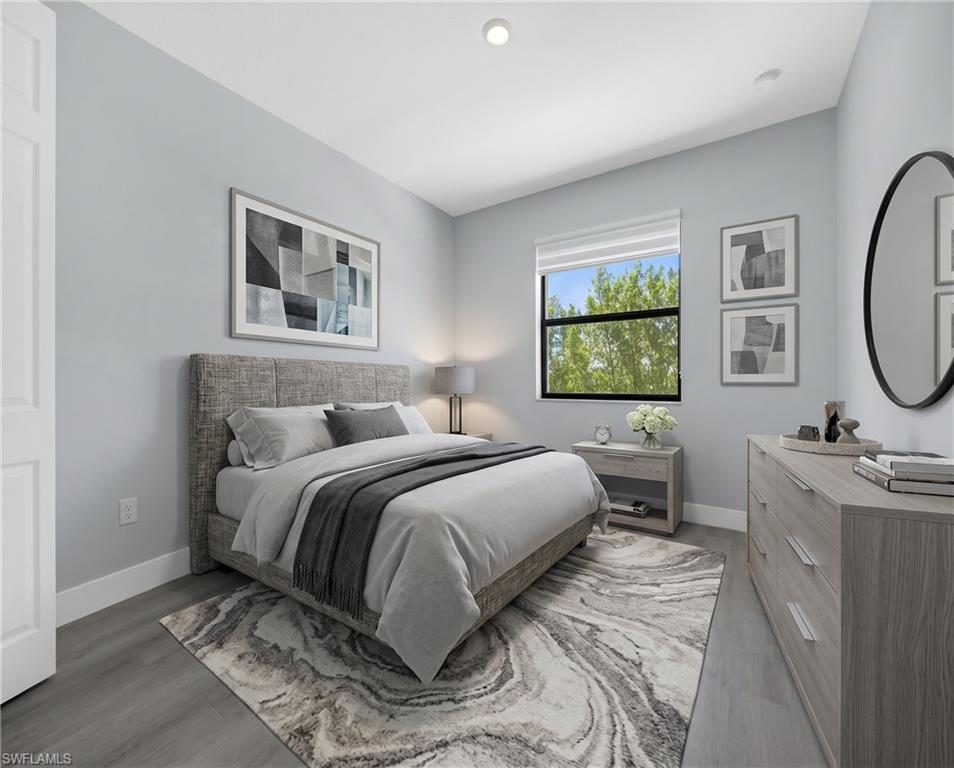 9045 Madrid Circle Naples, FL 34104 - Photo 24 of 46 Virtually Staged*Well-proportioned bedroom featuring wood-finish flooring, a window with exterior views, recessed lighting, baseboard trim, and light gray walls