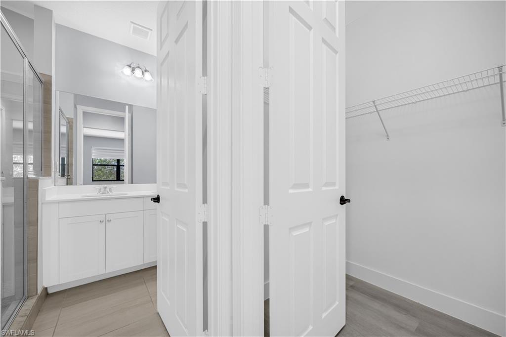 9045 Madrid Circle Naples, FL 34104 - Photo 28 of 46 a spacious bathroom with a shower