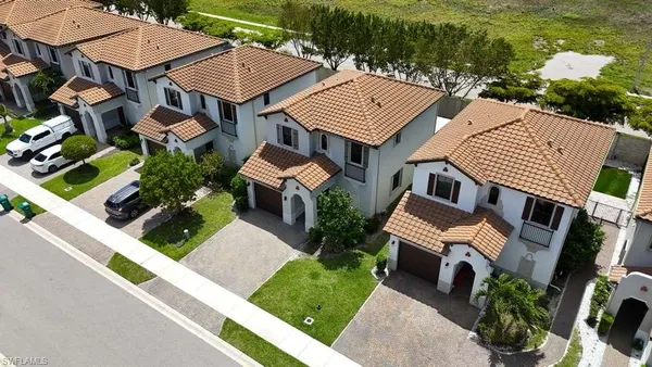 an aerial view of a house with garden space and street view