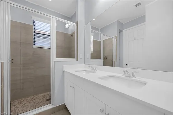 a bathroom with a shower sink and mirror
