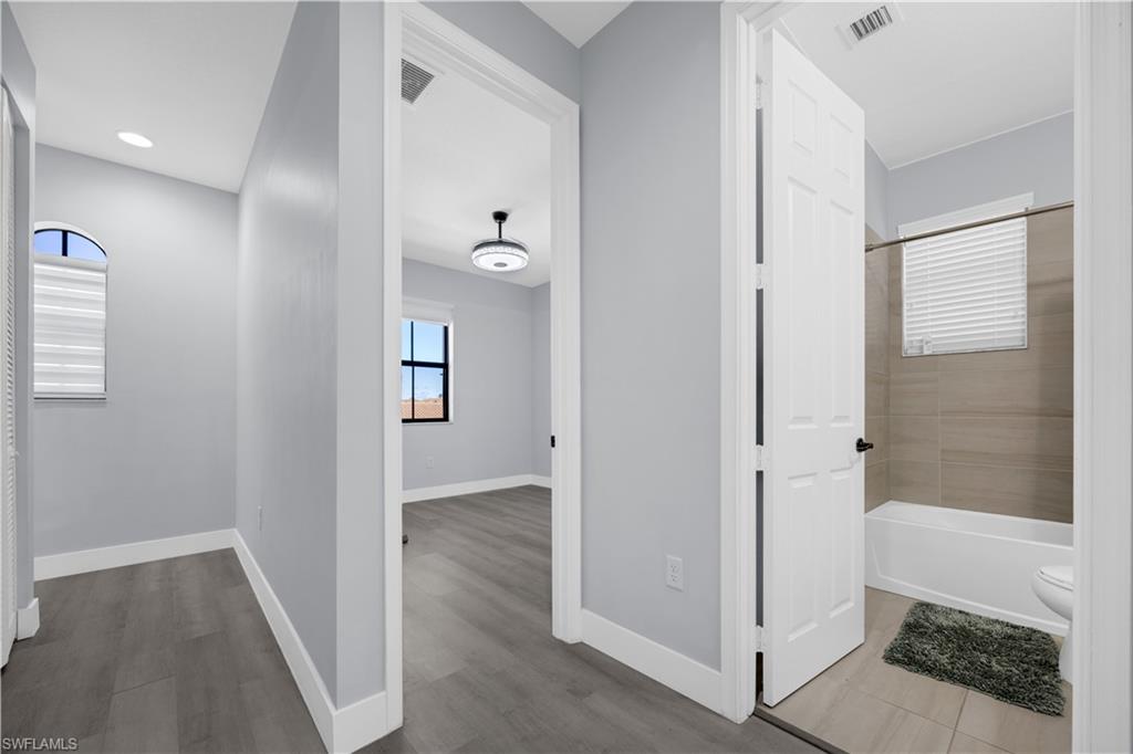 9045 Madrid Circle Naples, FL 34104 - Photo 35 of 46 a view of a bathroom with wooden floor