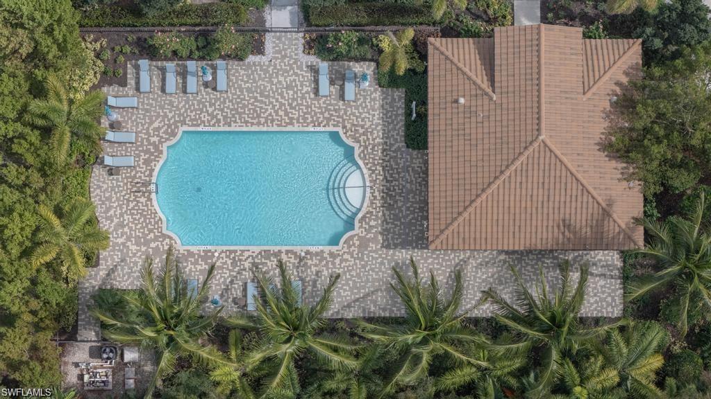 9045 Madrid Circle Naples, FL 34104 - Photo 46 of 46 an aerial view of a house with a swimming pool and large trees