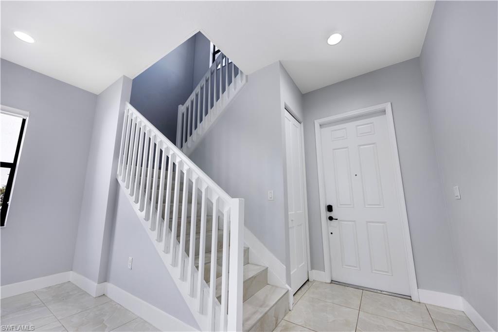 9045 Madrid Circle Naples, FL 34104 - Photo 9 of 46 a view of a hallway with entryway and closet