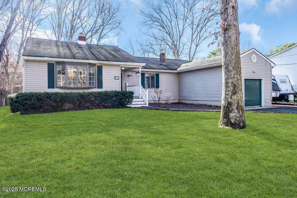 a front view of a house with a garden and yard