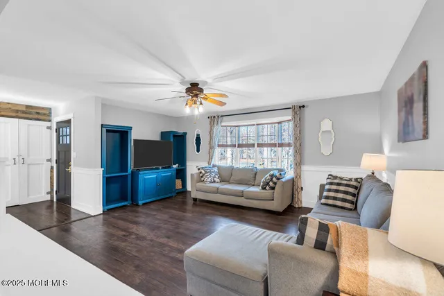 a view of a livingroom with wooden floor and a window