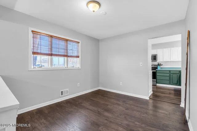 a view of a dining room with furniture a chandelier and wooden floor