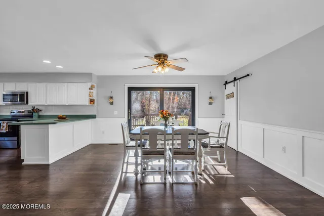 a view of a dining room with furniture and a kitchen