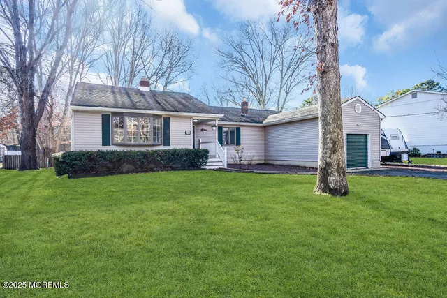a front view of house with yard and green space
